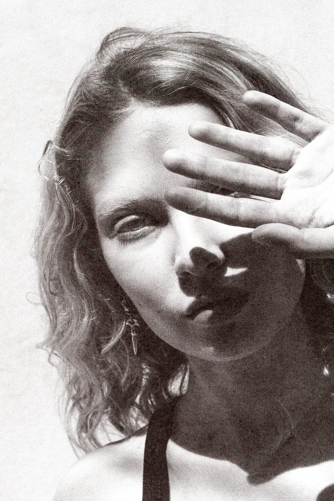 Black and white portrait with a hand across the face — NIKA, by Kenneth Kemp
